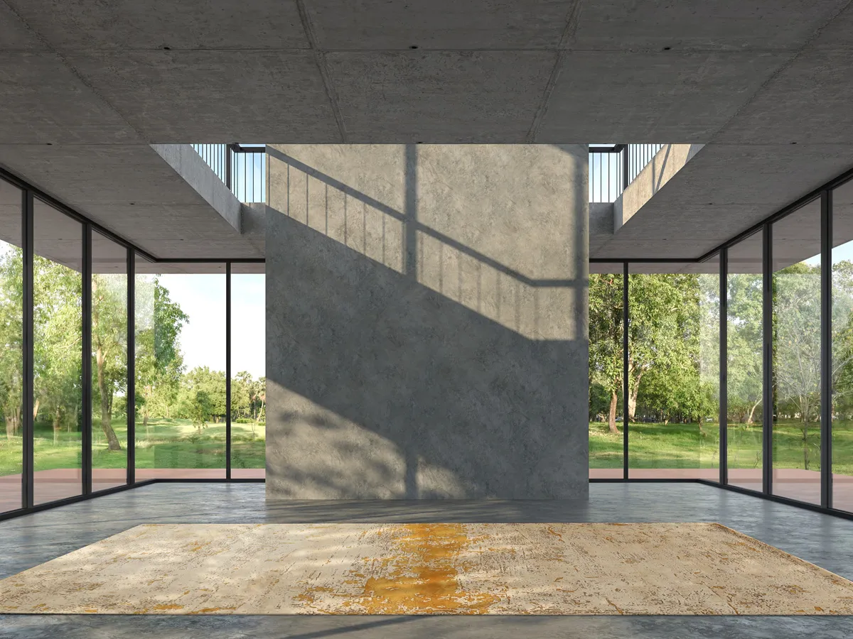 Foto of Abstract Rug in gold and sand tones placed in a room of concrete & glass windows through which you can see the green woods